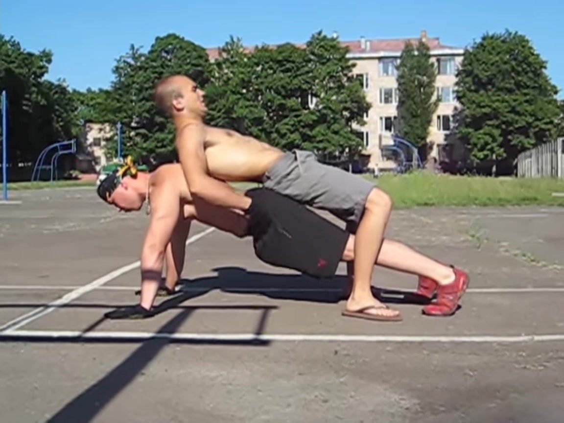 Man does 20 human weighted push ups