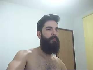 Bearded man stroking his cock