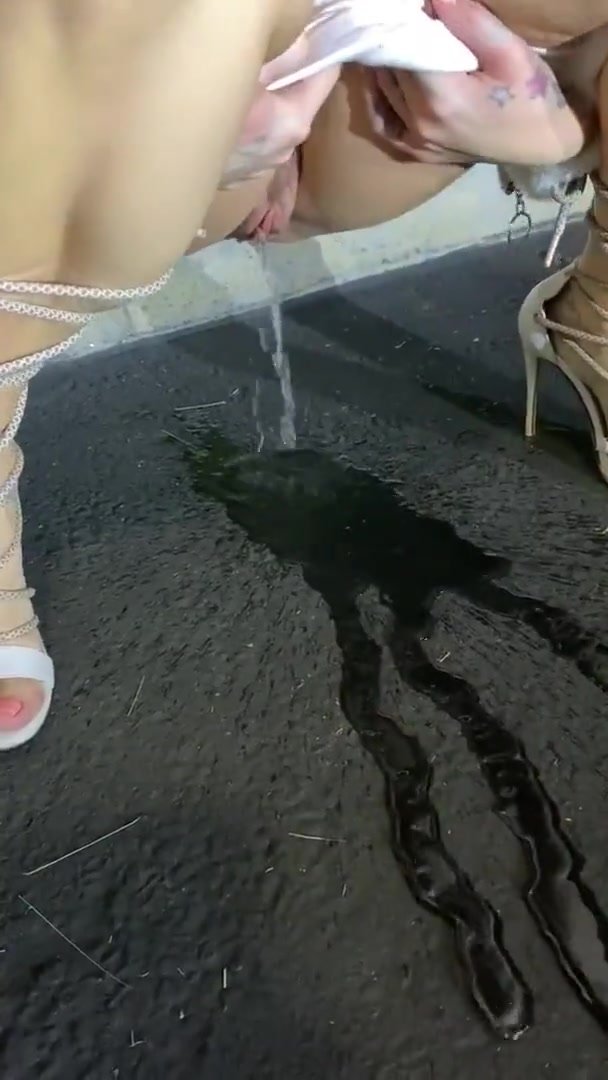 Sexy squat pee floods the pavement
