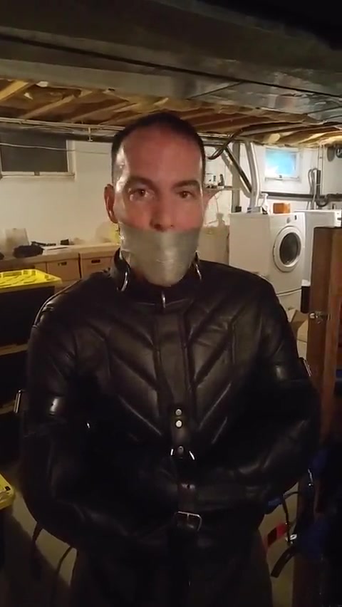 chained and tape gagged and left  in a straitjacket