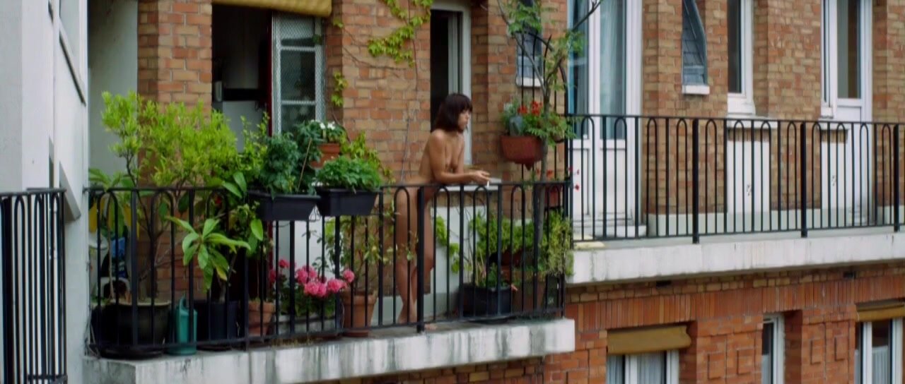 Standing naked in balcony