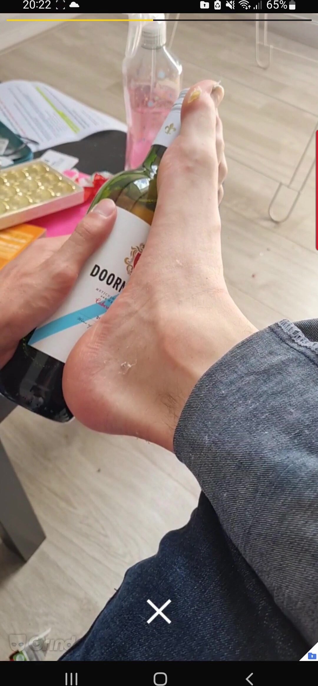 Huge feet compared to wine bottle