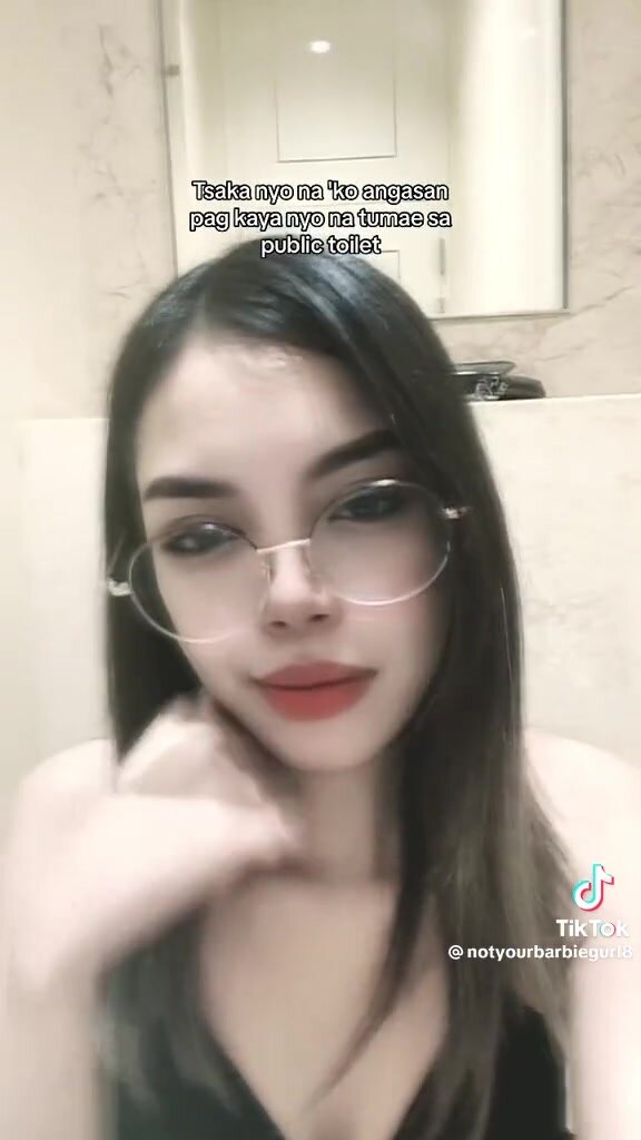 Girl with glasses in the bathroom