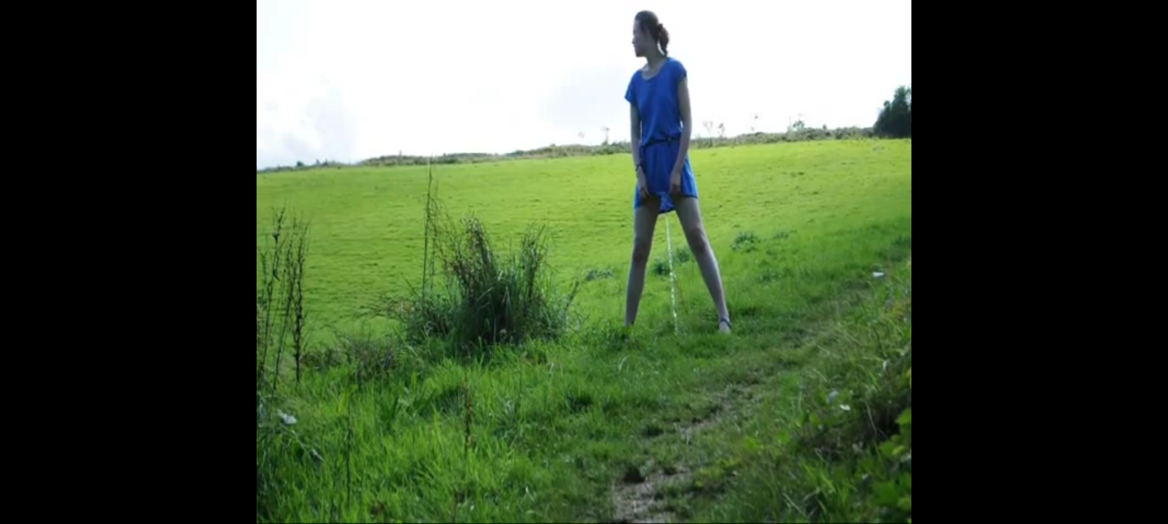 Pee standing in a field