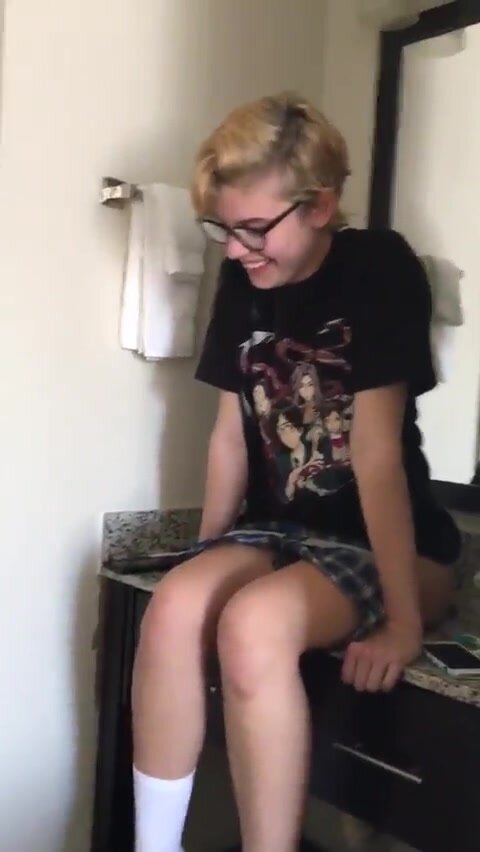 Fun nerdy girl pees in sink in front of friend