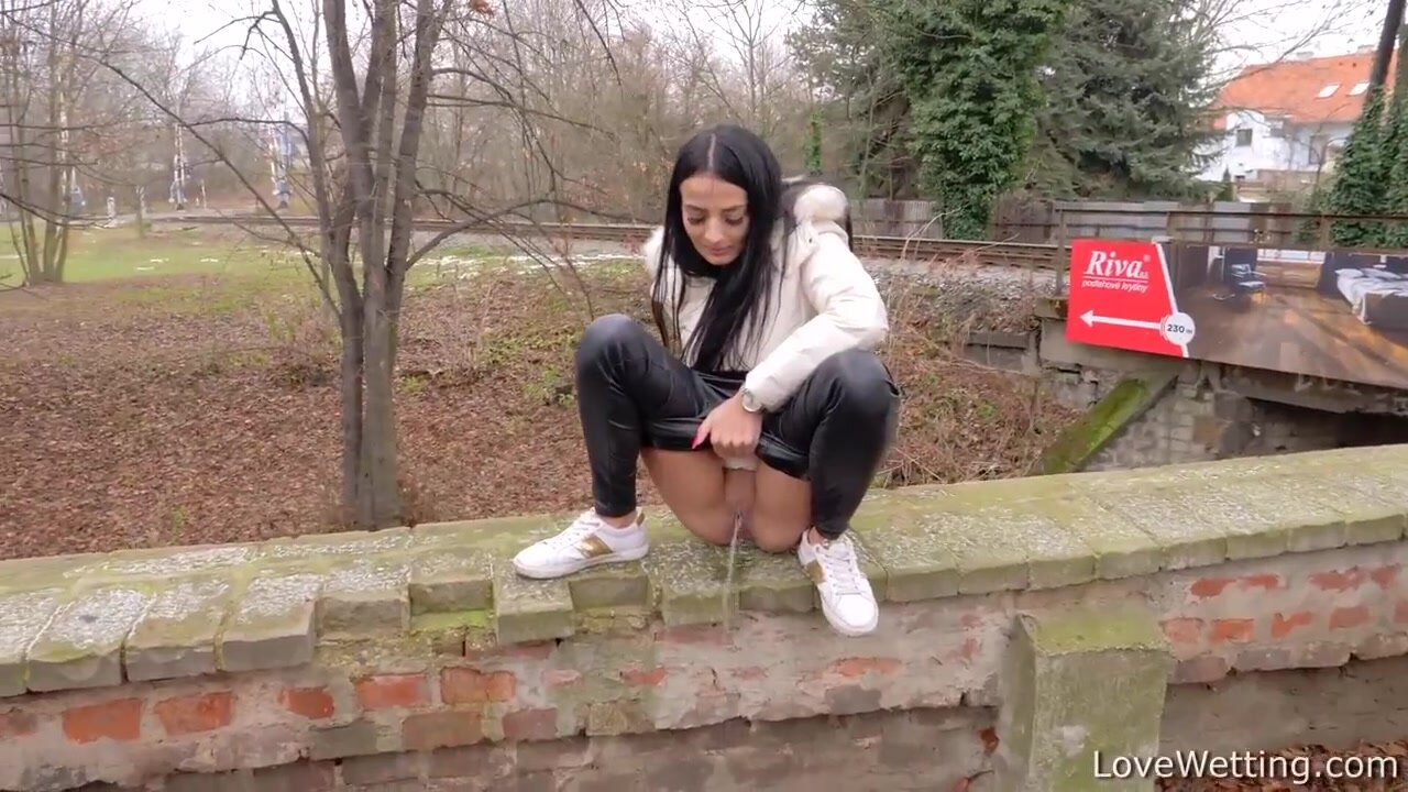 Girl peeing from a wall