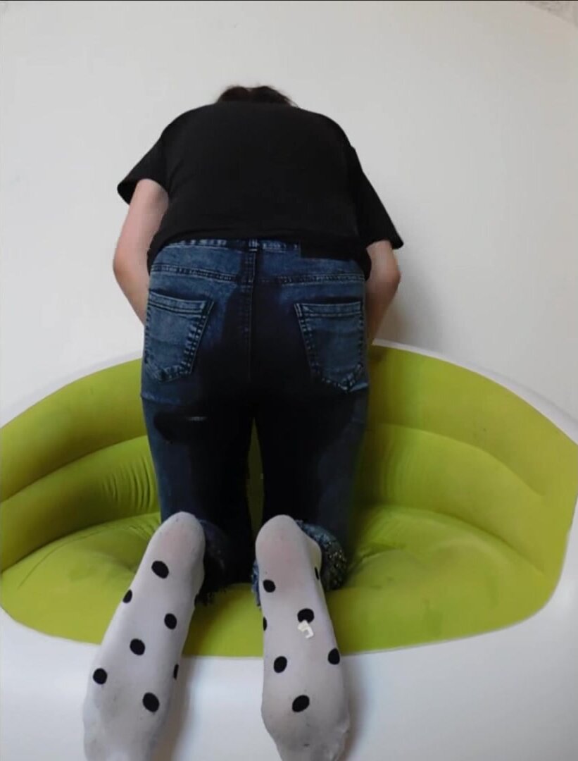 Girl wets her tight jeans sitting on inflatable chair