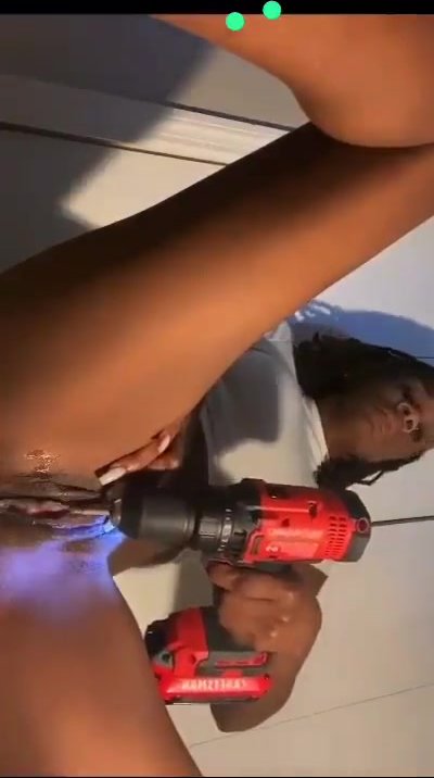 Ebony uses a power drill on her clit, seems to enjoy it