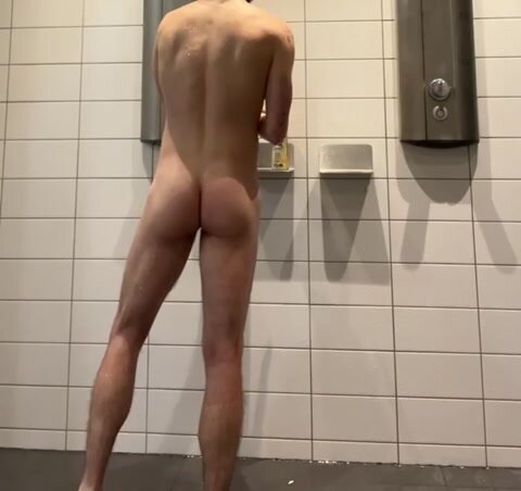 horny guy plays with himself in gym locker room shower