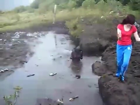 girl jumps in the mud